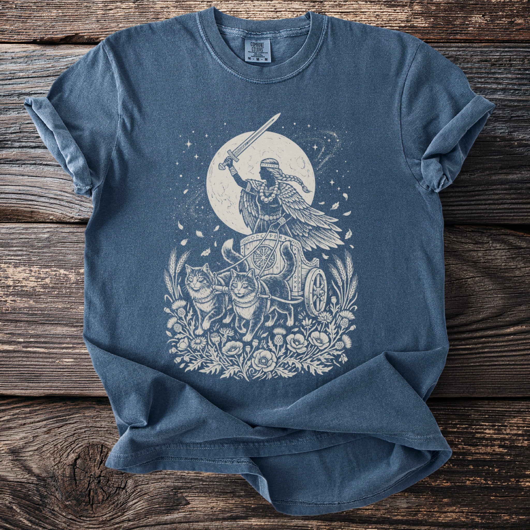 Celestial goddess riding a chariot pulled by cats, with sword raised against a moonlit sky.