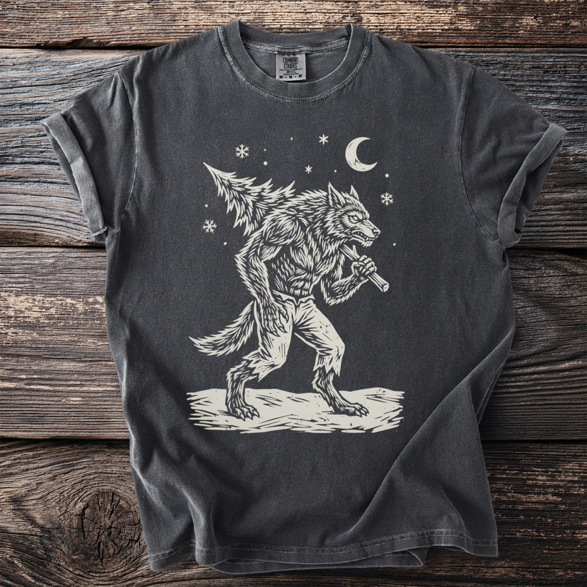 Pepper gray t-shirt with a cream folk-cut print: a snarling werewolf in torn trousers walks through the snow with a fir tree over his shoulder.