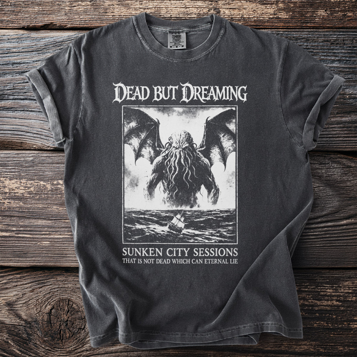 T-shirt with "Dead But Dreaming" and tentacled creature graphic.