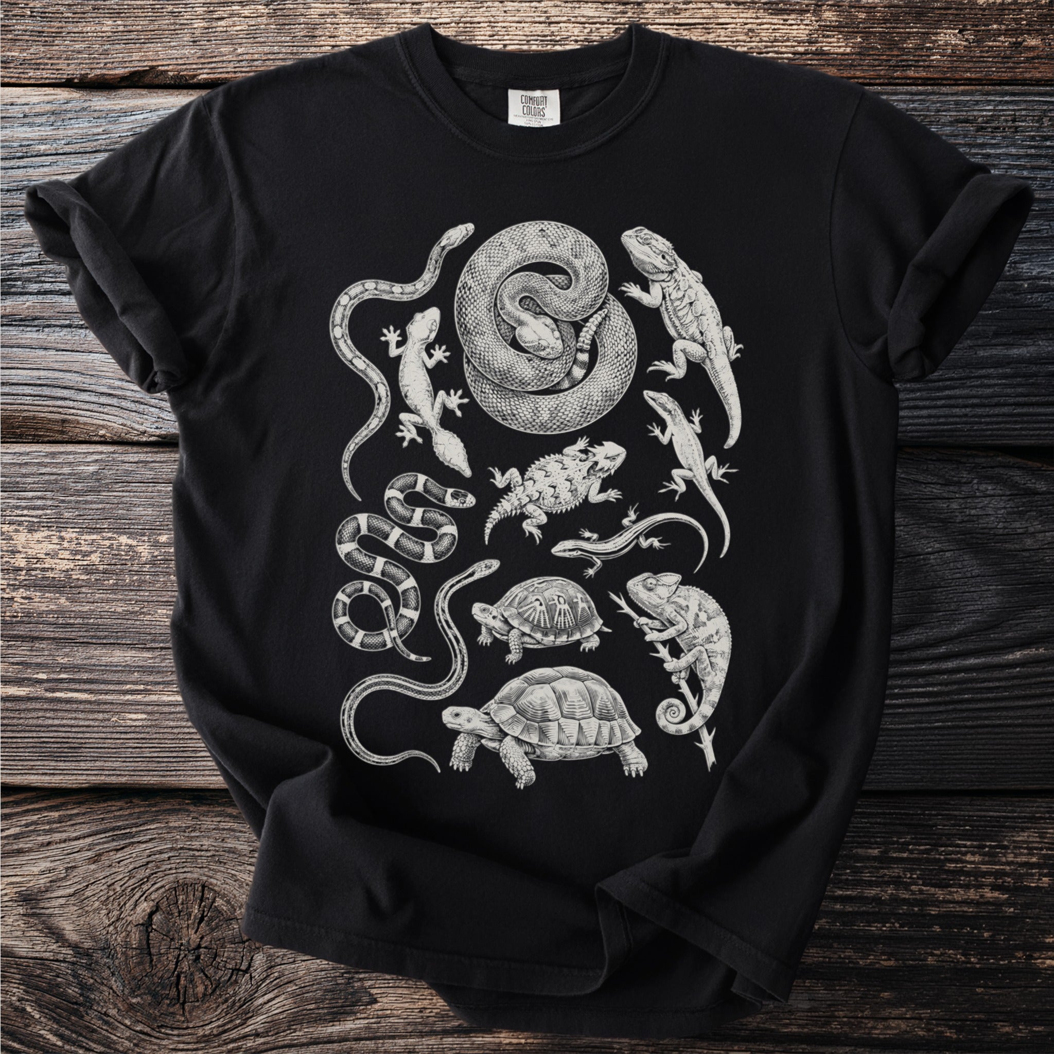 Black t-shirt with a white illustration of various reptiles and amphibians.