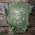 Green t-shirt with white mystical horned creature and Christmas ornaments design.