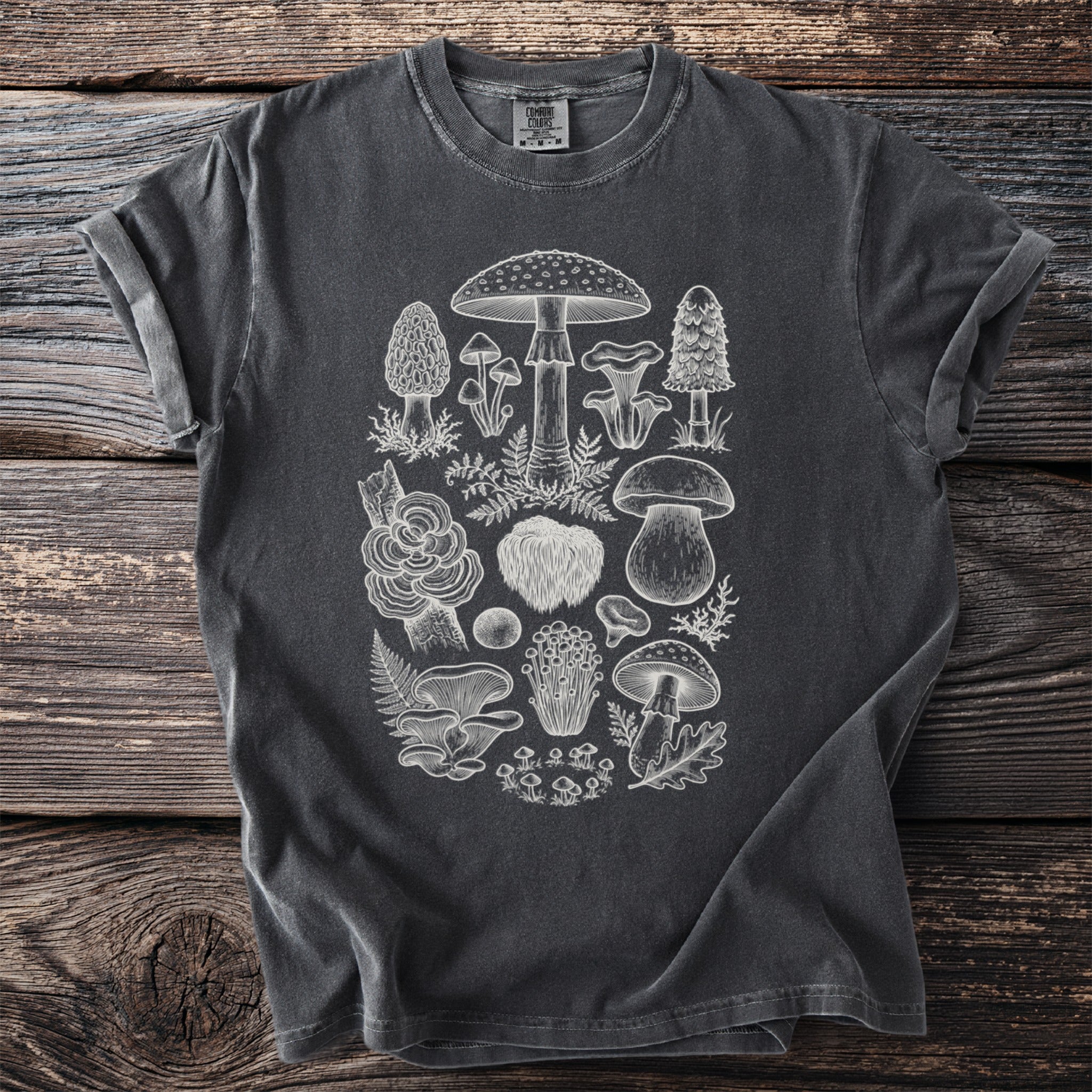 Dark charcoal t-shirt with a detailed white line drawing of various mushrooms and foliage.