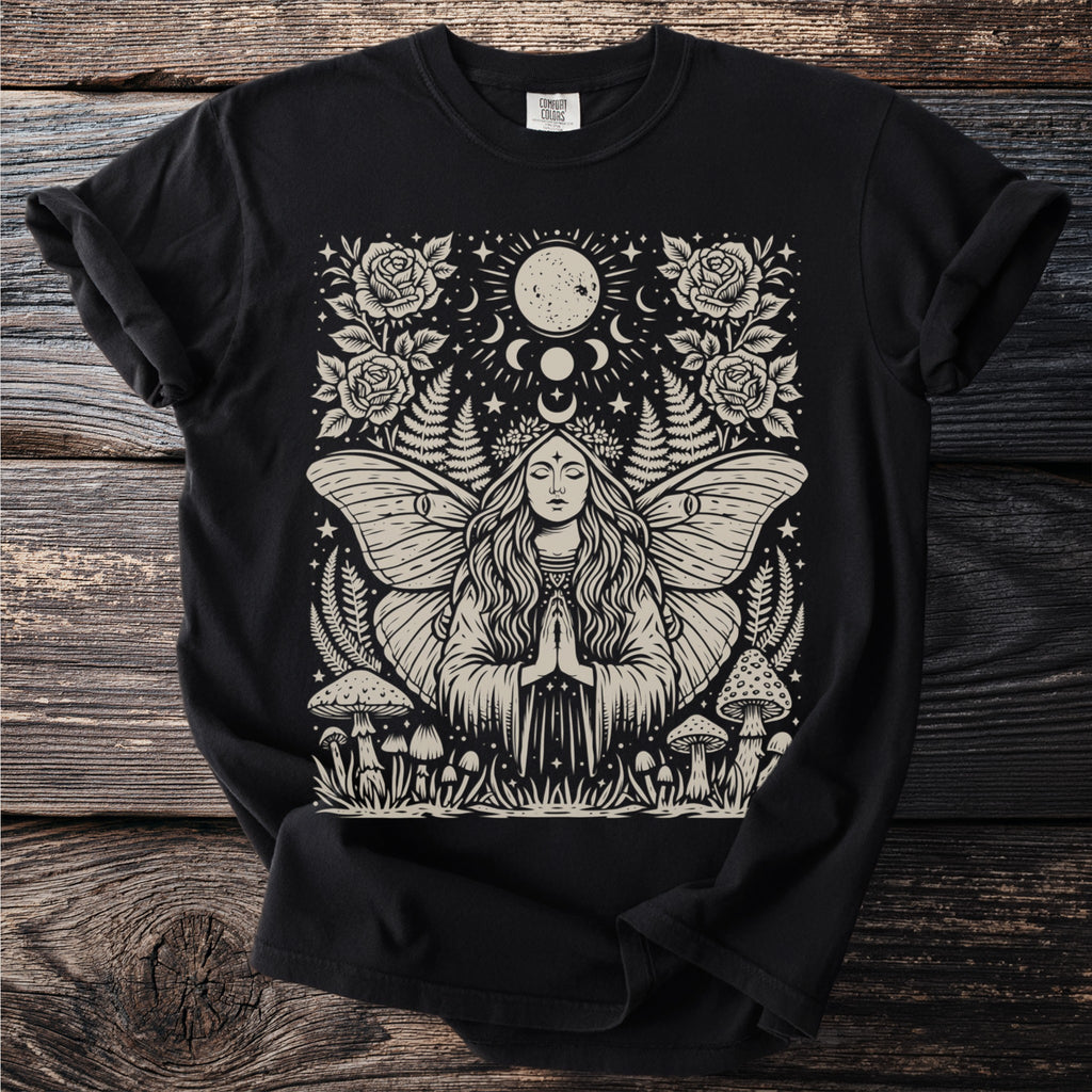 Black t-shirt with a pagan-themed graphic featuring a woman with moth wings, moon, mushrooms, and roses.