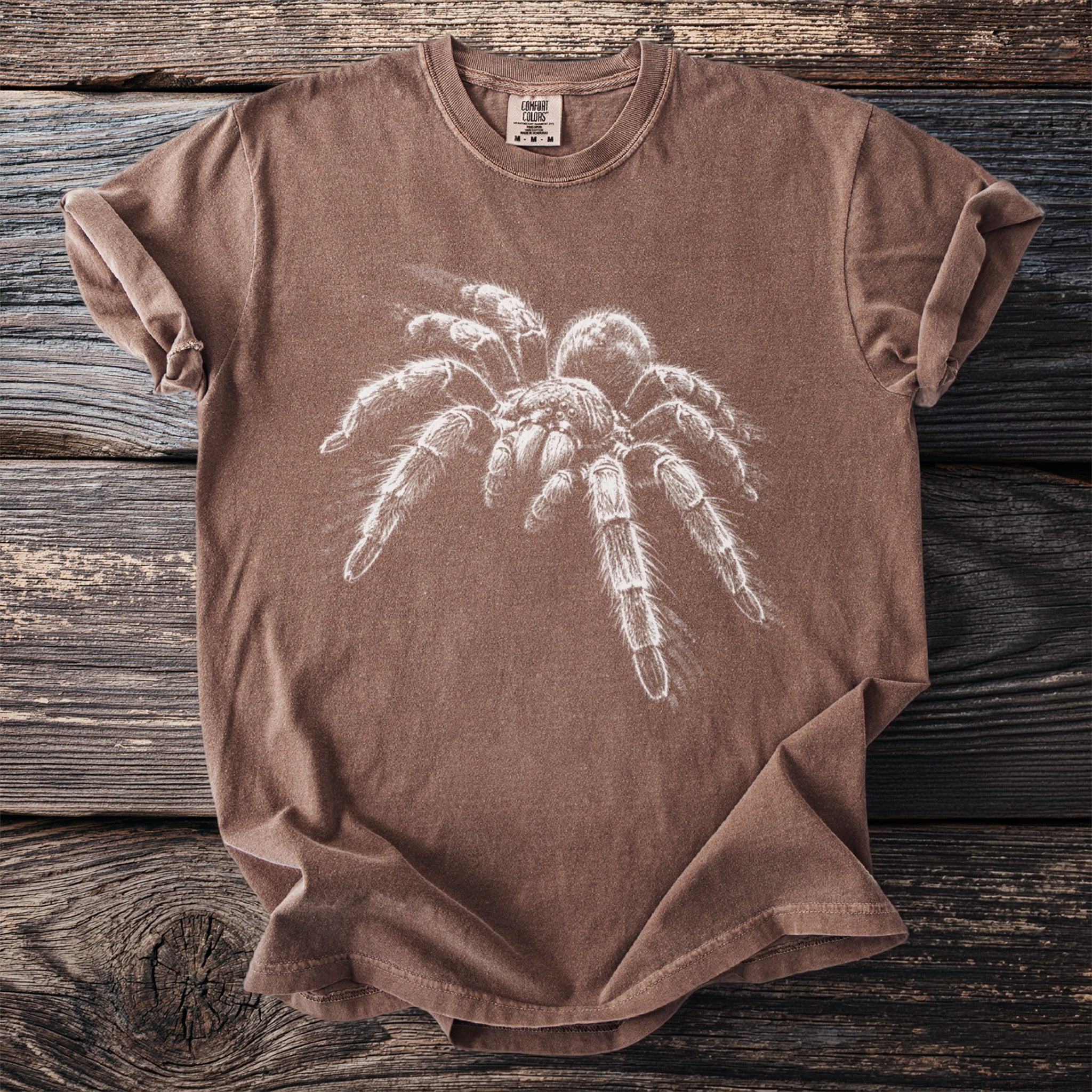 Brown t-shirt with white tarantula graphic and Comfort Colors tag.