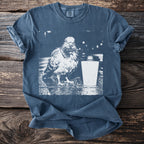 Blue t-shirt with a graphic of a pigeon next to a coffee cup.