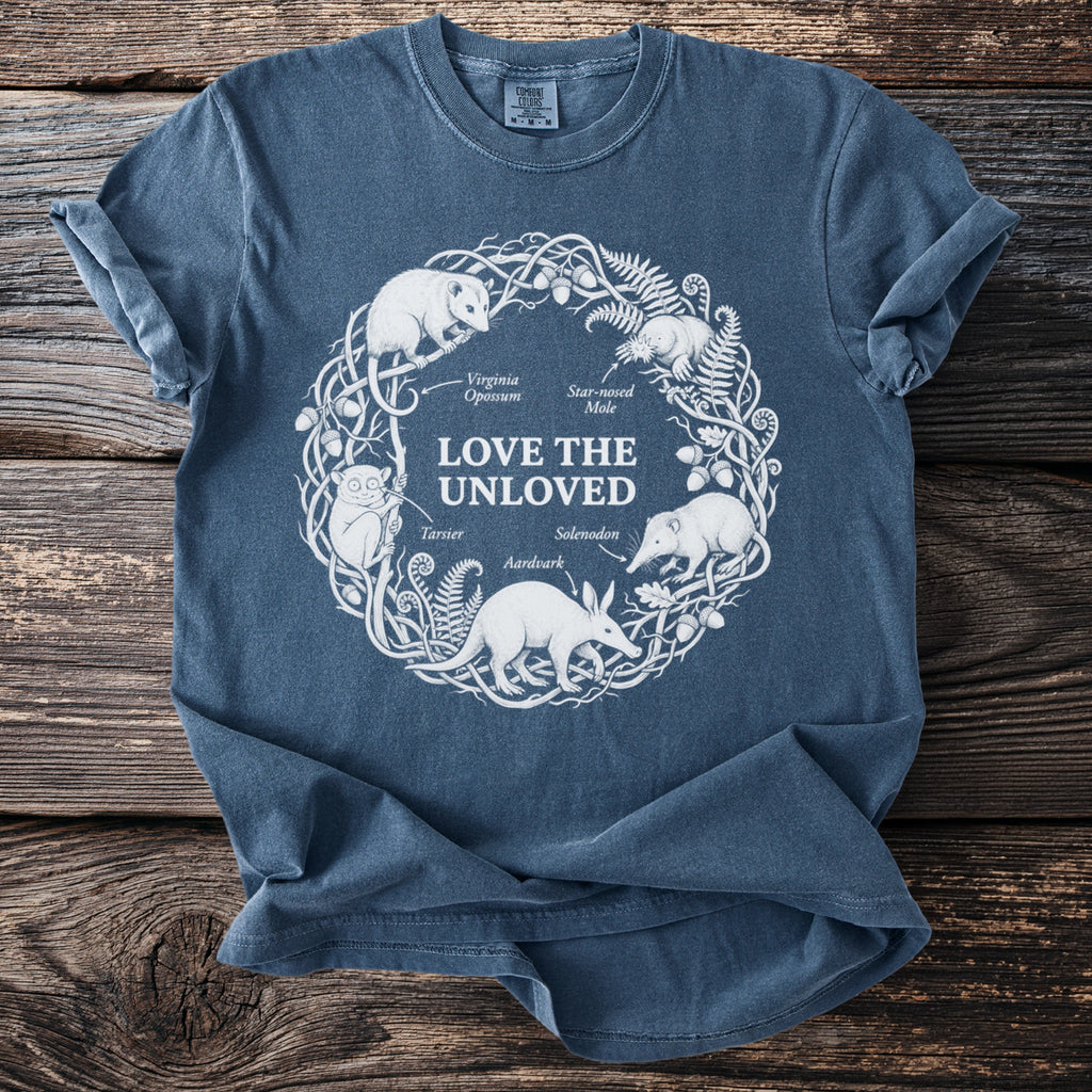 Blue t-shirt with "LOVE THE UNLOVED" text and animals in a circular design.