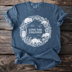 Blue t-shirt with "LOVE THE UNLOVED" text and animals in a circular design.