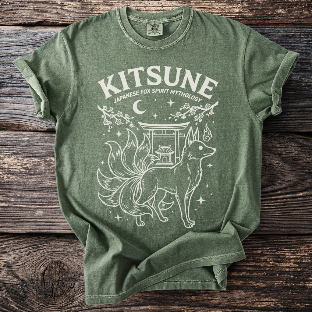 Green t-shirt with white graphic of a nine-tailed fox and Japanese shrine.