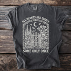 Dark t-shirt with Gothic design of plants, skull and text: "ALL PLANTS ARE EDIBLE, SOME ONLY ONCE."