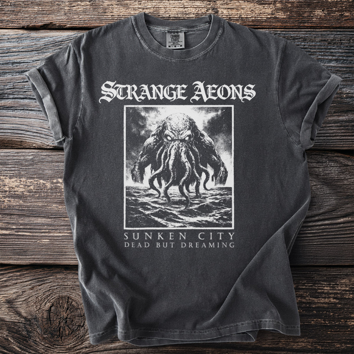 Dark t-shirt with Strange Aeons logo, a tentacled creature, and text.