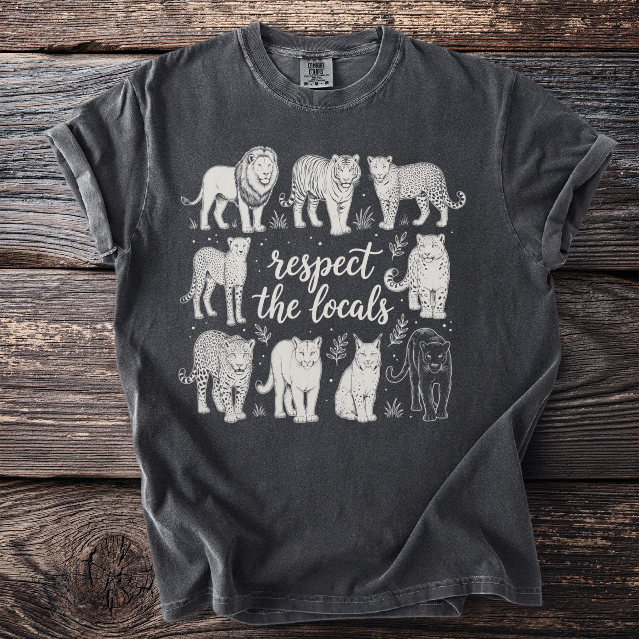 Charcoal t-shirt with white line art of nine wild cats and text "respect the locals."