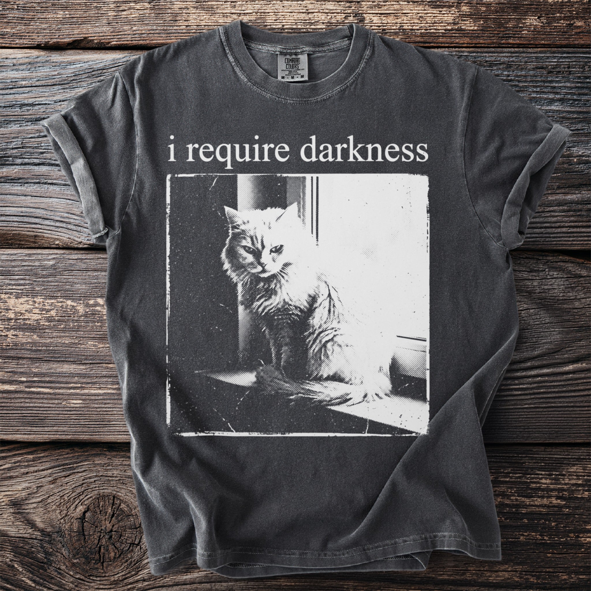 T-shirt with "i require darkness" text above a fluffy cat image.