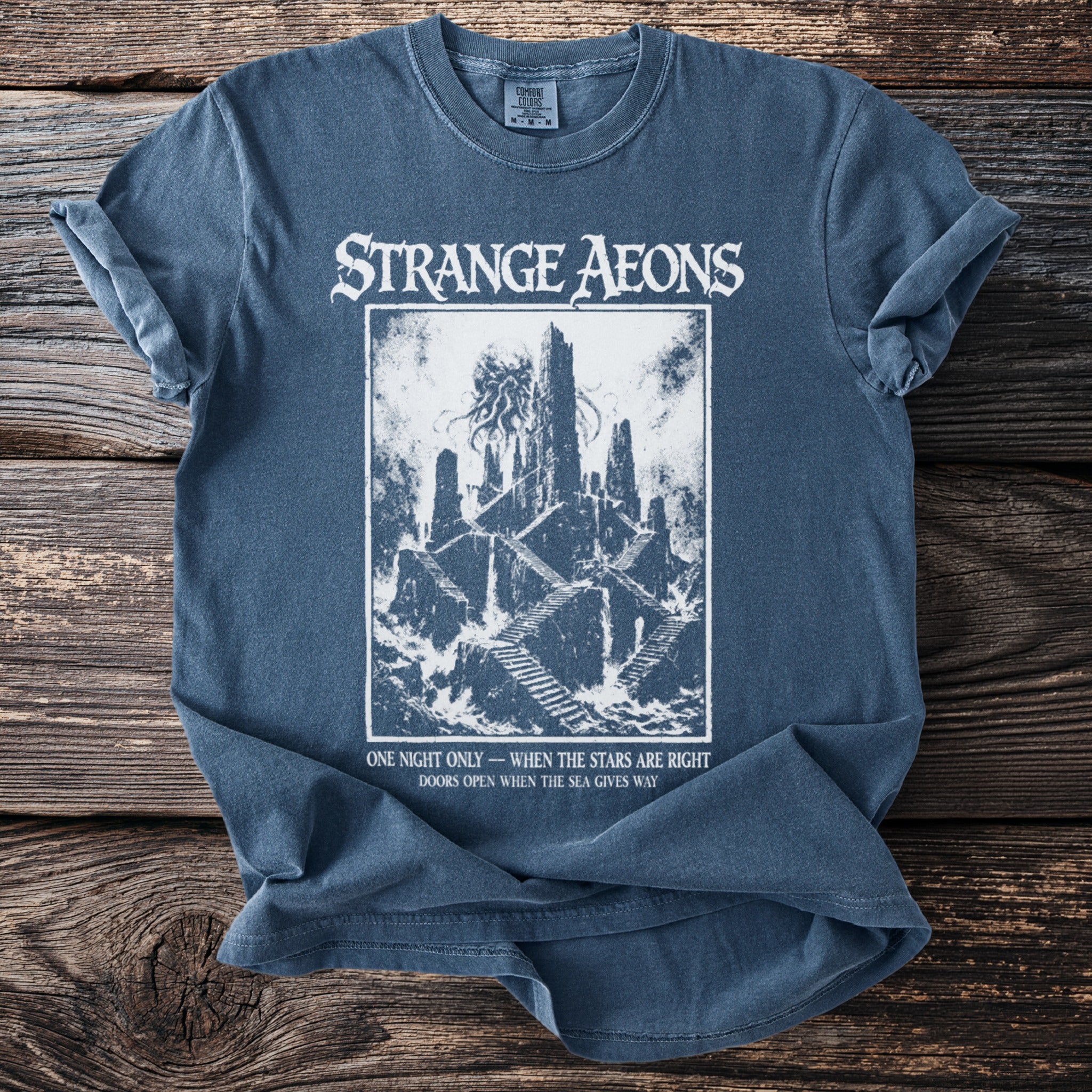 Strange Aeons t-shirt with castle and tentacles design and text.