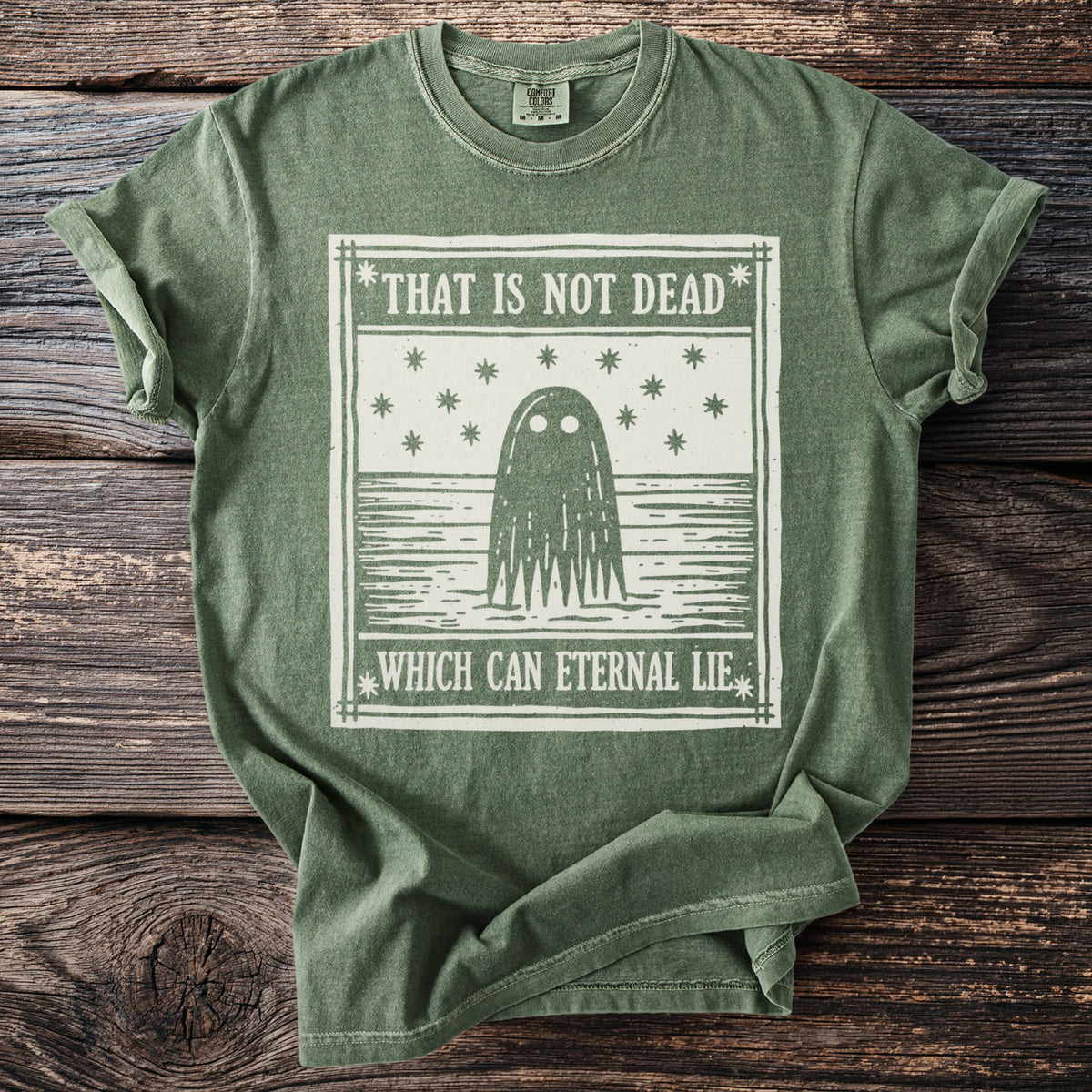 Green t-shirt with a graphic of a ghost surrounded by stars and text.