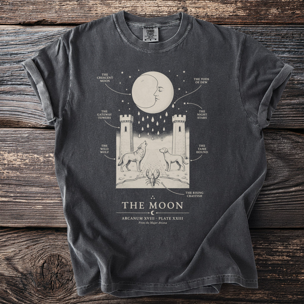 Dark grey t-shirt with "The Moon" artwork depicting a crescent moon, towers, wolf, dog, and lobster.