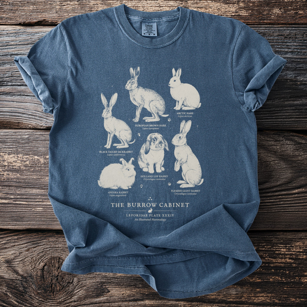 T-shirt with illustrations of various rabbits and hares and text "The Burrow Cabinet".