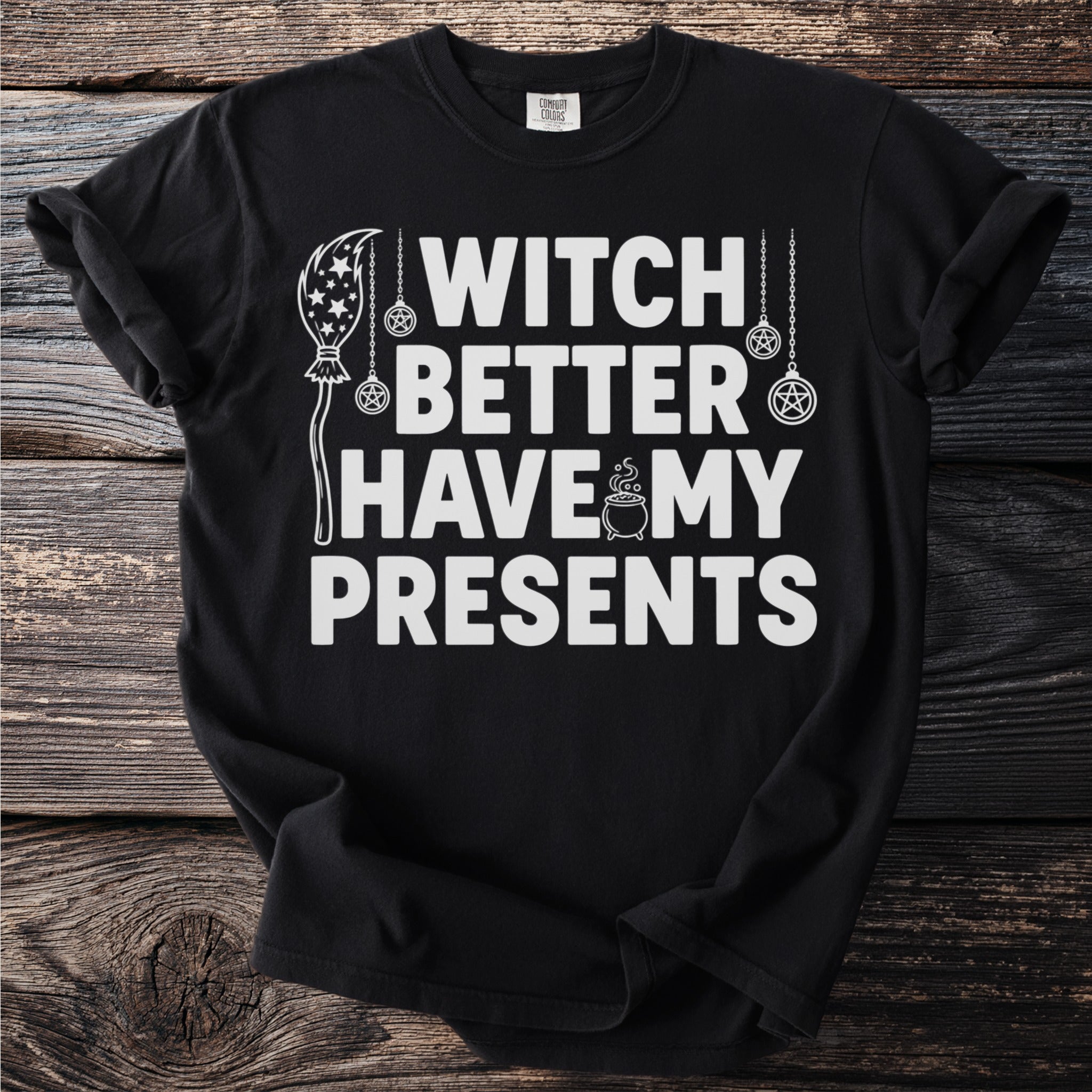 Black t-shirt with white text "WITCH BETTER HAVE MY PRESENTS" and witchy graphics.