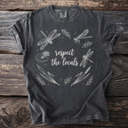 Charcoal t-shirt featuring a circular design of dragonflies, cattails, and water lilies with text "respect the locals".