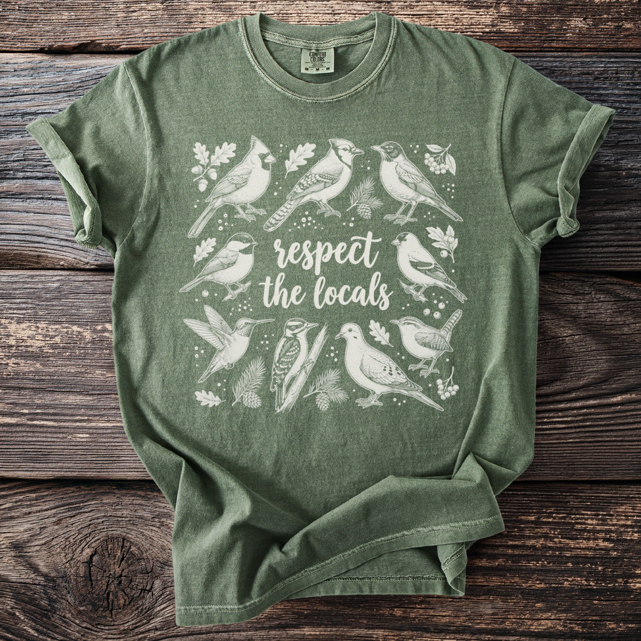 Green t-shirt with various birds and text "respect the locals".