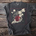 Skeleton hand holding a pomegranate with daffodils within a red square frame.