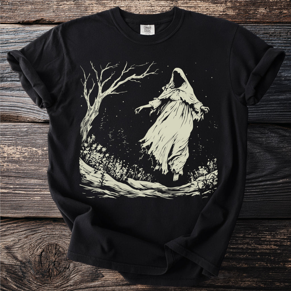 Black t-shirt with a cream-colored illustration of a ghost and bare tree in a starry field.