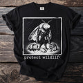 T-shirt graphic featuring a moth, raccoon, opossum, and frog with text "protect wildlife".