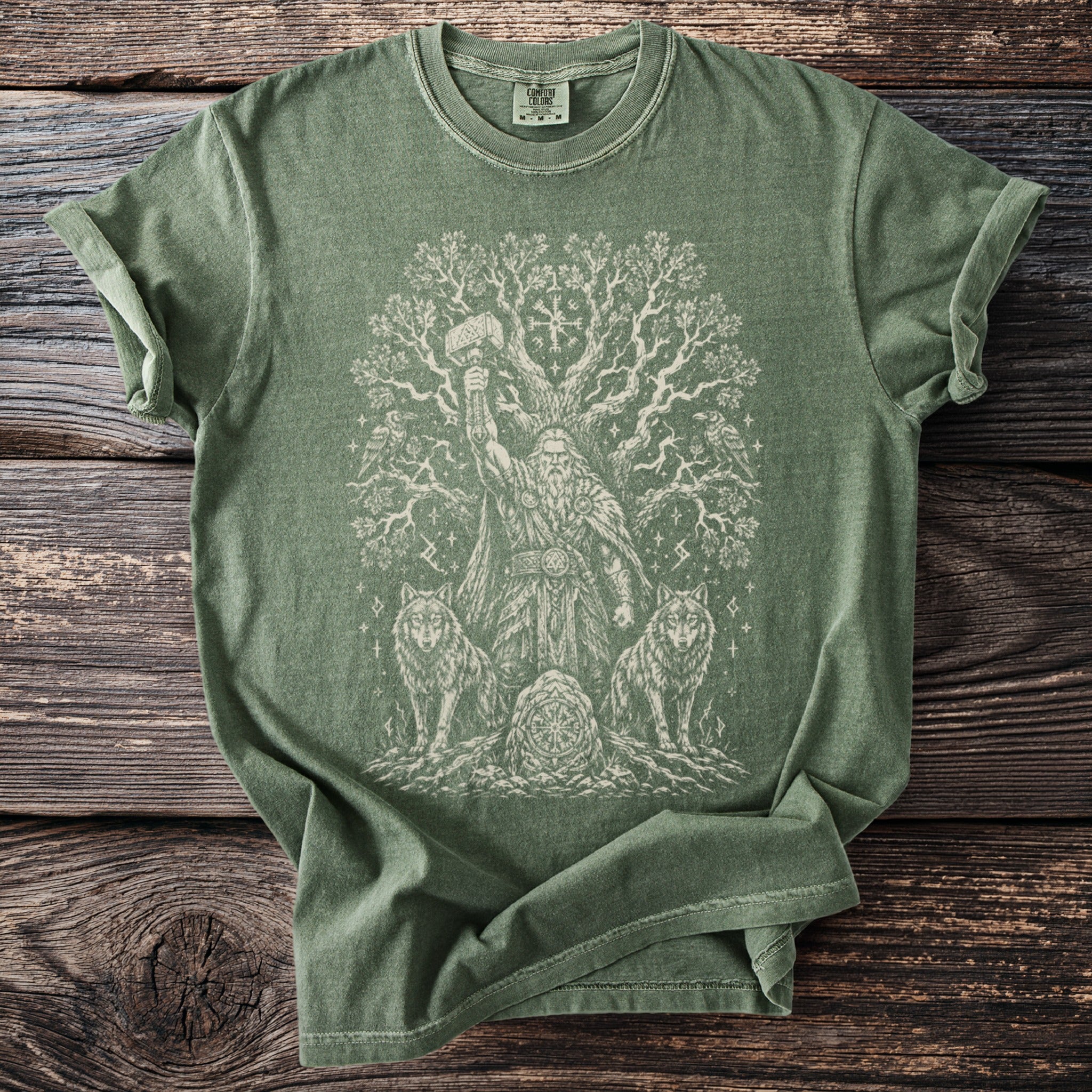 Green t-shirt with a white Odin, wolves, tree, and Thor's hammer design.