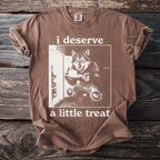 Brown t-shirt with "i deserve a little treat" text and wolf graphic.