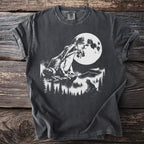 T-shirt with graphic of frogs and moon in a forest landscape.