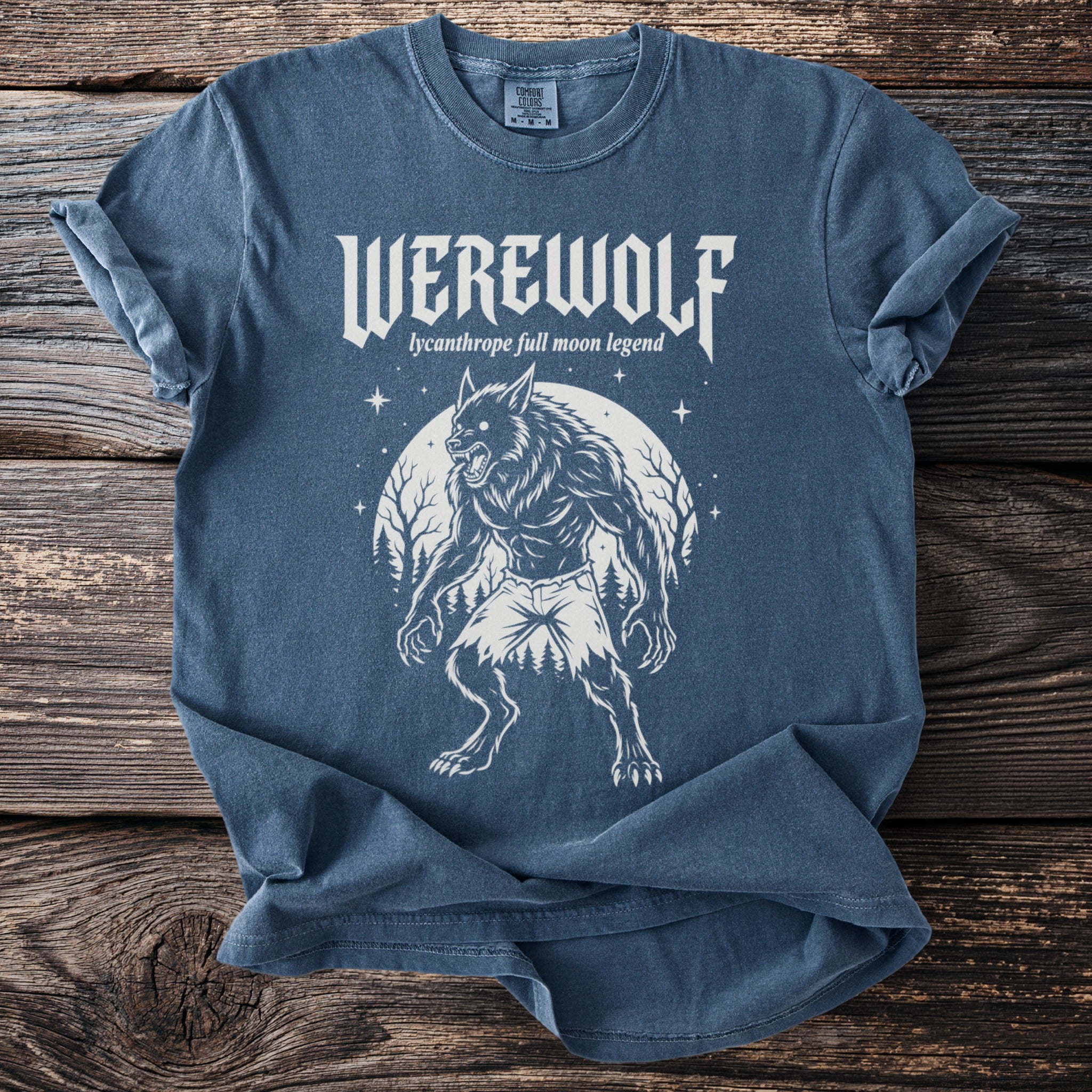 A blue t-shirt with a white werewolf graphic and "WEREWOLF lycanthrope full moon legend" text.
