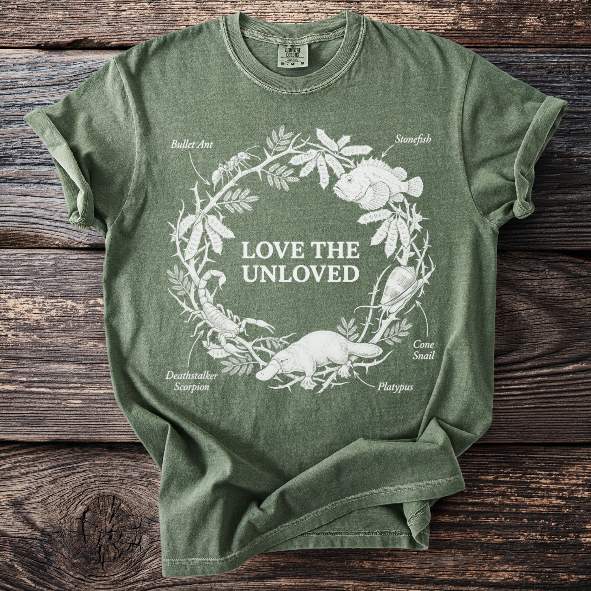 Green t-shirt with white line art of animals and text "Love the Unloved."