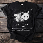 Black T shirt with an opossum and the text “non perceivable creature”.