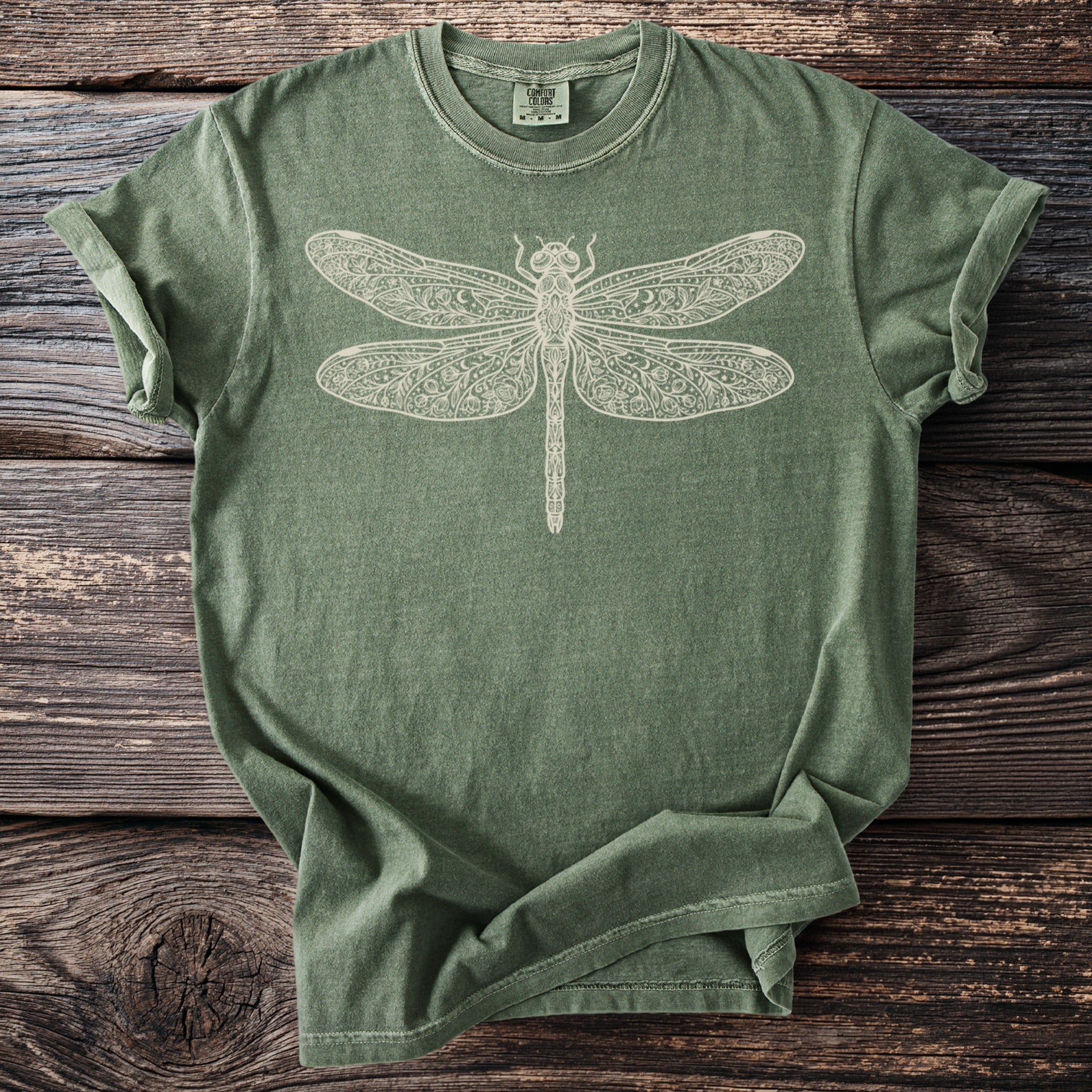 Green t-shirt with a white decorative dragonfly graphic and Comfort Colors label.