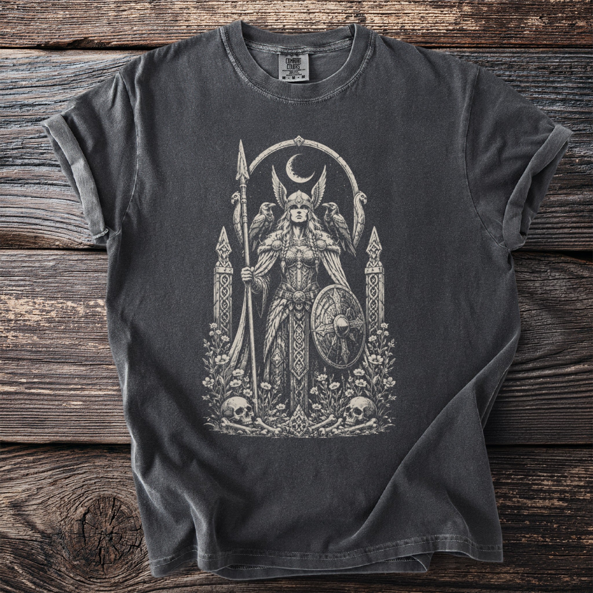 Black t-shirt with vintage graphic of a winged warrior, raven, shield, crescent moon, skulls, and flowers.