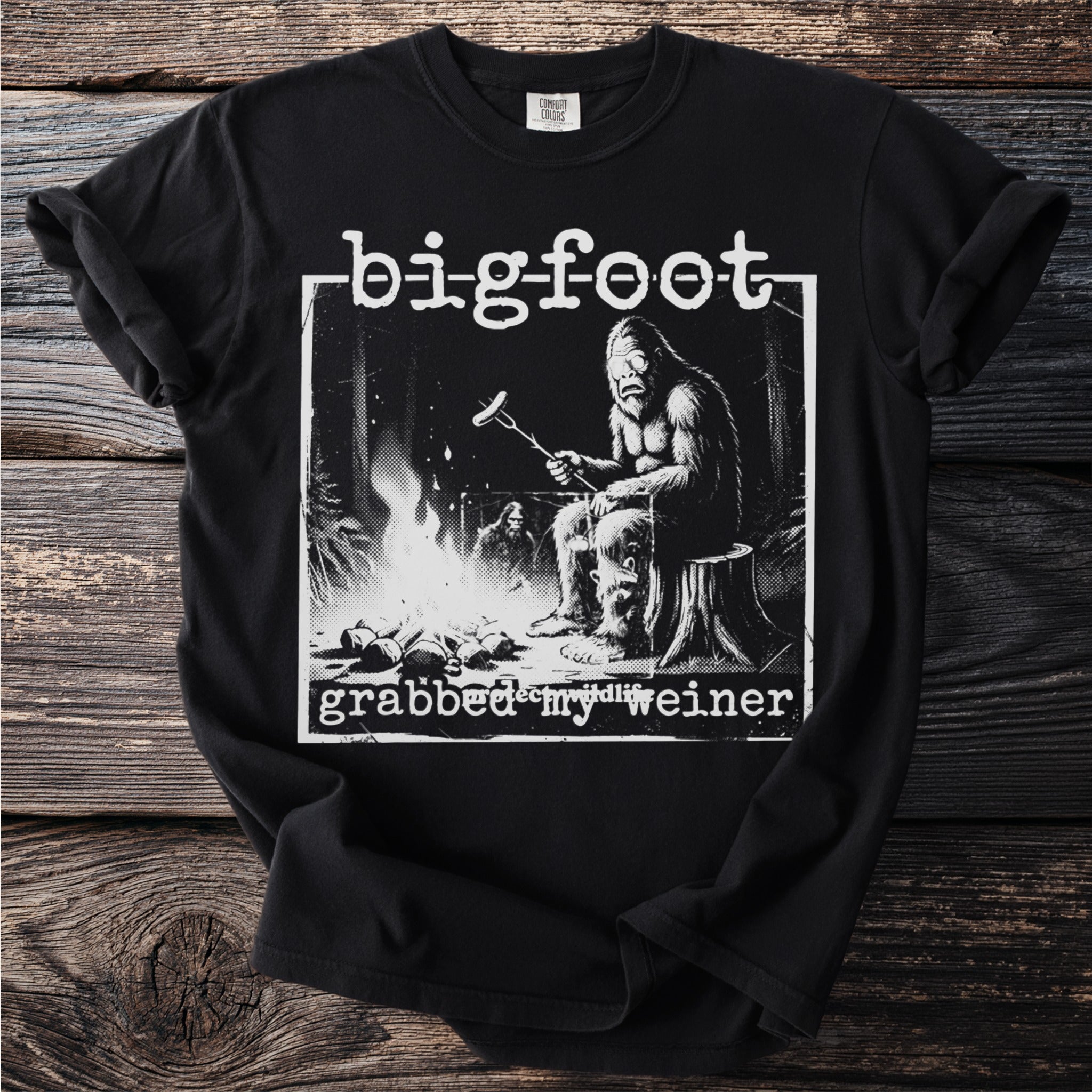 Bigfoot grilling a hot dog over a campfire with text "bigfoot grabbed my weiner".