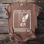 Brown t-shirt with a kitten graphic and the text "please do not perceive me."