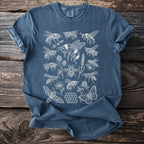 Blue t-shirt with a white line drawing of bees, butterflies, moths, clover, and honeycomb.