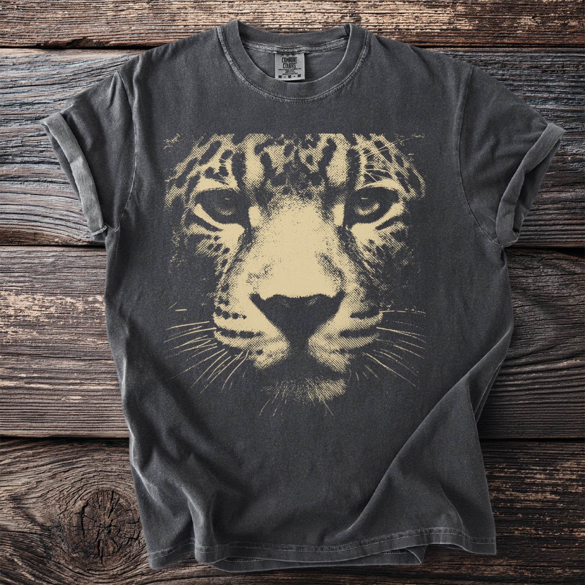 Dark gray t-shirt with a distressed light tan leopard face graphic and "Comfort Colors" tag.