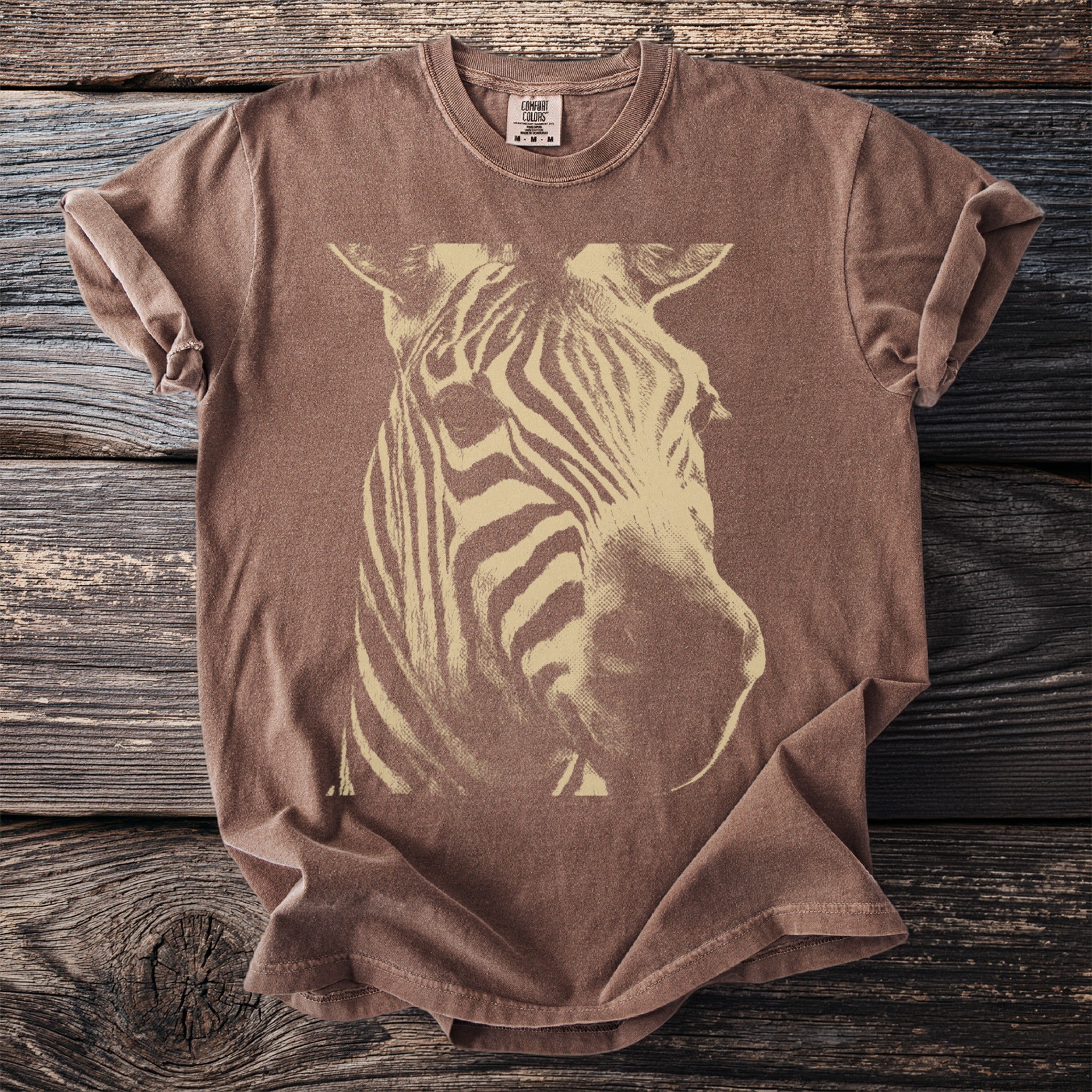 Brown t-shirt with a large cream-colored zebra head graphic.