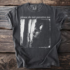 Dark t-shirt with a black cat peeking from behind a tree and text "please do not perceive me".