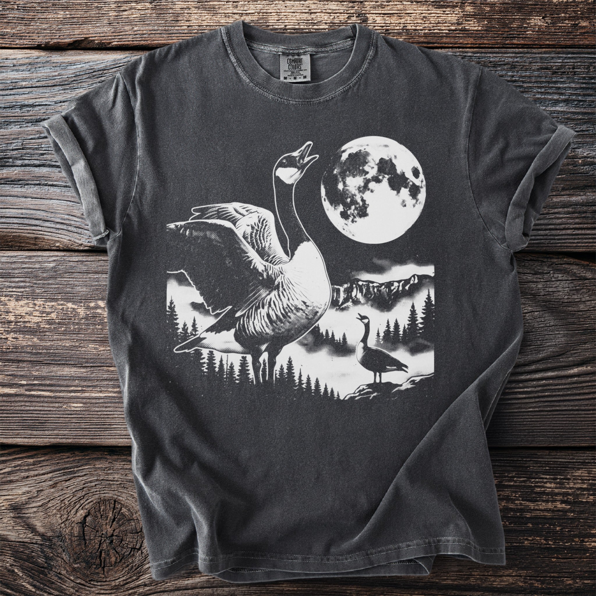 T-shirt graphic: goose under moon with mountains and trees