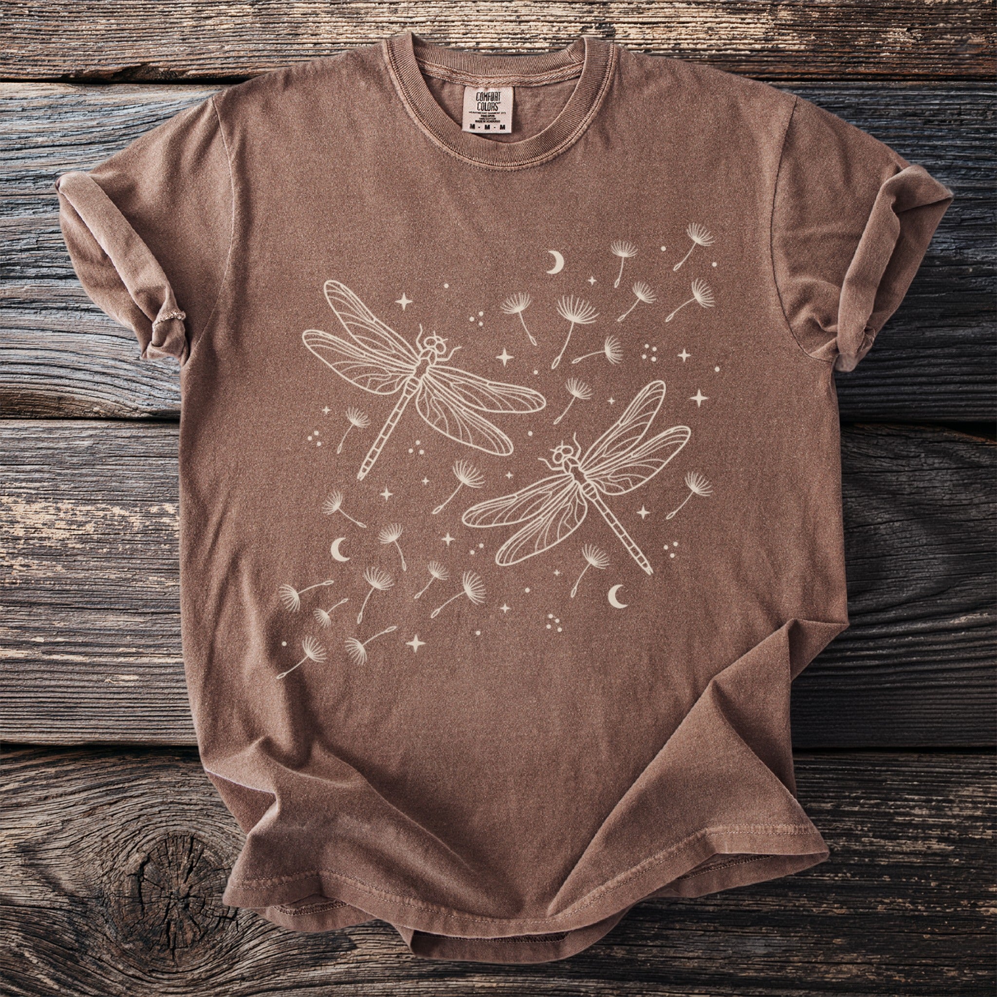 Brown t-shirt with white dragonfly and dandelion seed print.