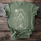 Green t-shirt with distressed print of a bear-man warrior with axe and spear by campfire.