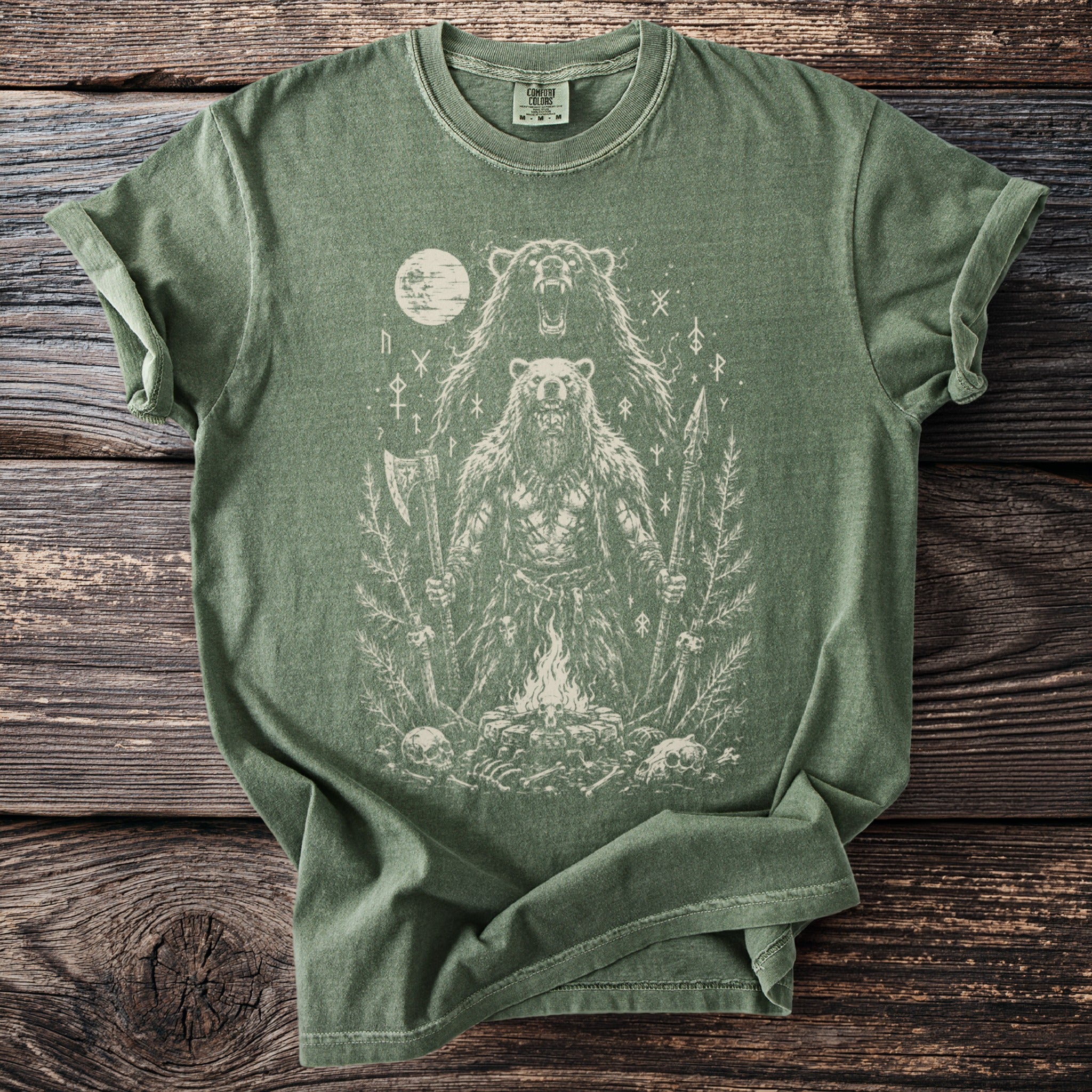 Green t-shirt with distressed print of a bear-man warrior with axe and spear by campfire.