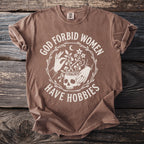 Brown t-shirt with white text and illustration of skull, hands, and plants.
