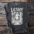 Dark gray t-shirt with white graphic of "LESHY" over a forest scene.