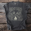Dark gray t-shirt with line art of mythical creatures sitting around a campfire.
