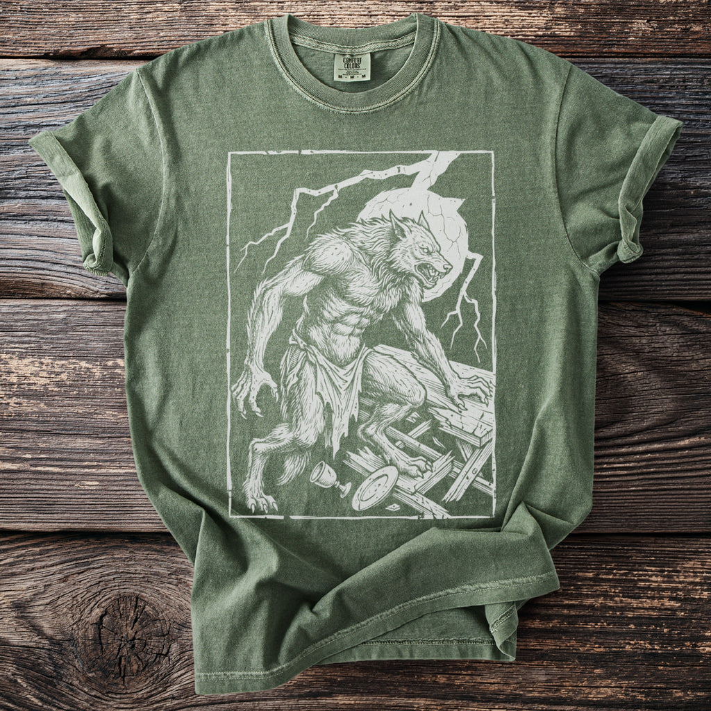 Green t-shirt with a distressed white line drawing of a werewolf on broken wooden planks.