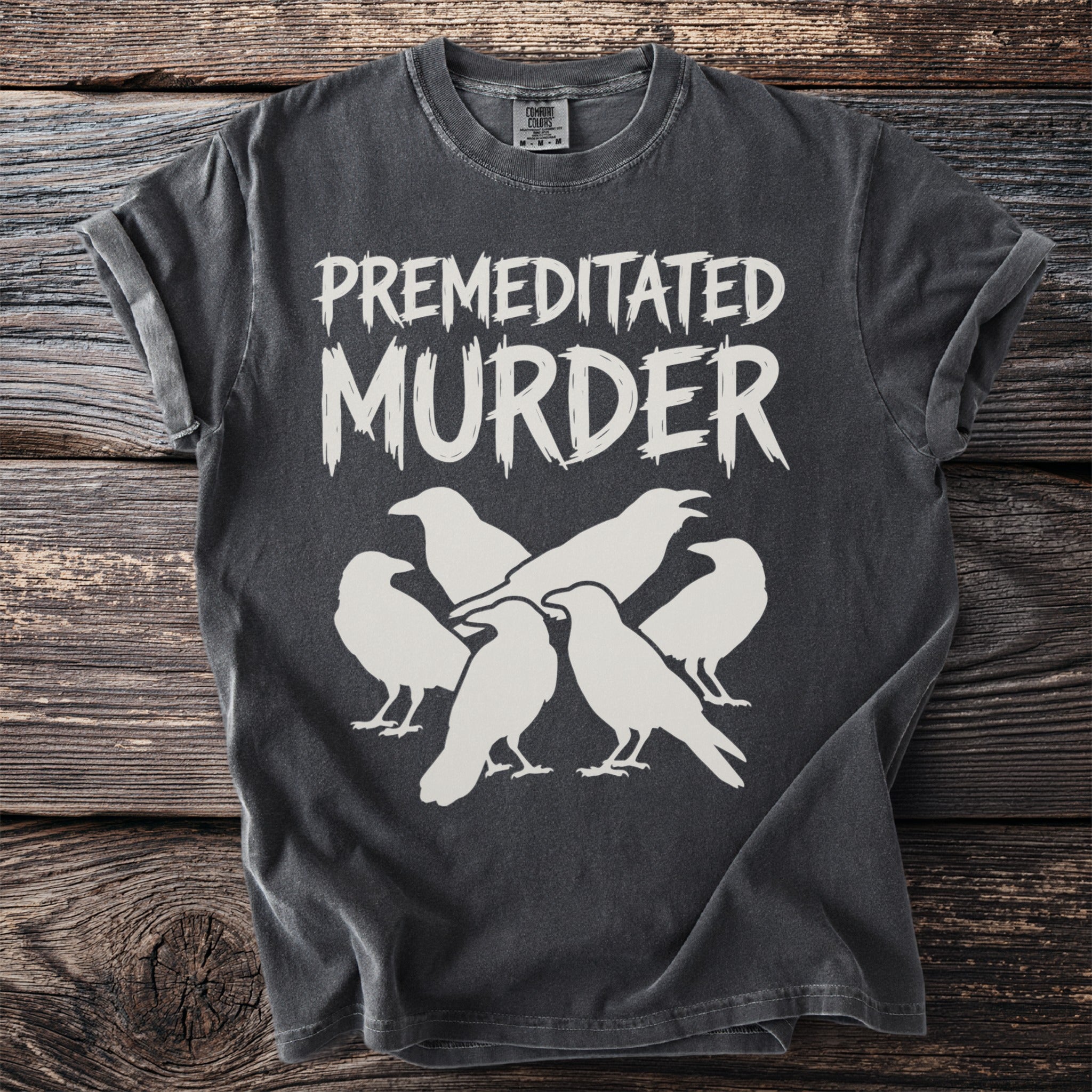 Dark grey t-shirt with "PREMEDITATED MURDER" text and white bird silhouettes.
