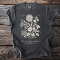 Dark grey t-shirt with "The Midnight Garden" botanical print and text.